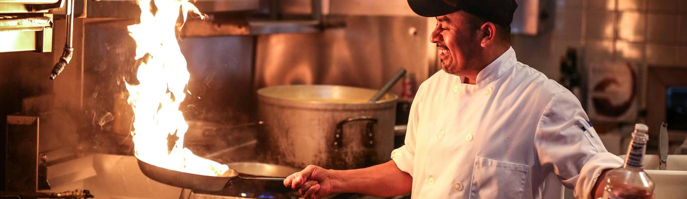 Chef checks chili temperature with probe thermometer