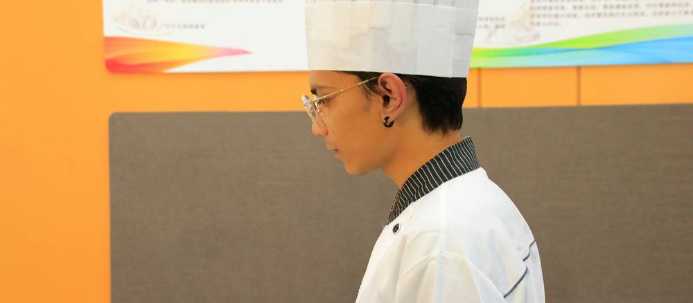 Food service manager studying food safety material in a commercial kitchen