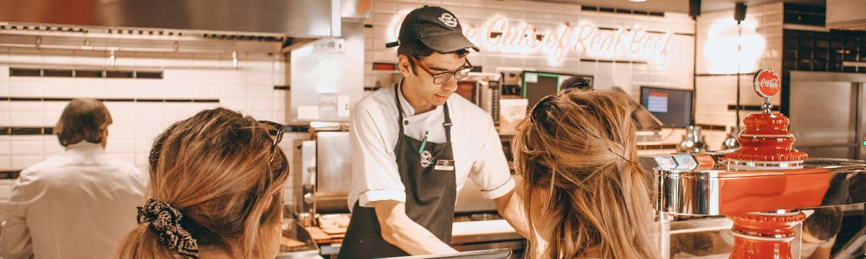 Georgia restaurant manager presenting food safety certificates to line employees