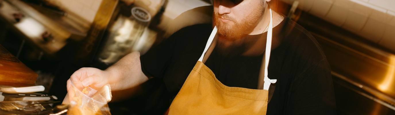 Chef applies an expiration label to prepped food in a Georgia restaurant