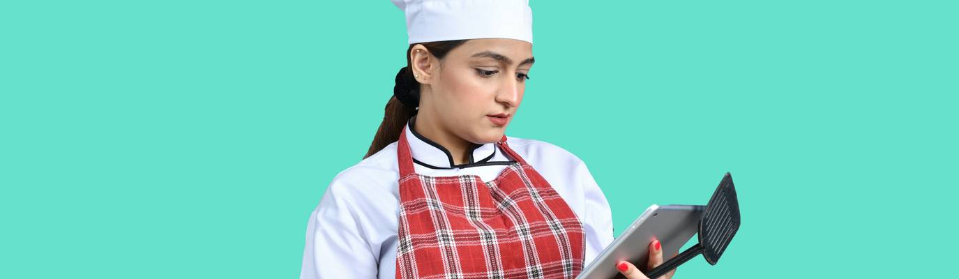 Chef taes a food safety quiz on a tablet in a Georgia restaurant kitchen