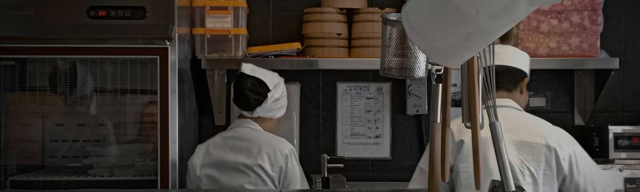 Georgia line cooks working during a lunch rush while a health inspector observes