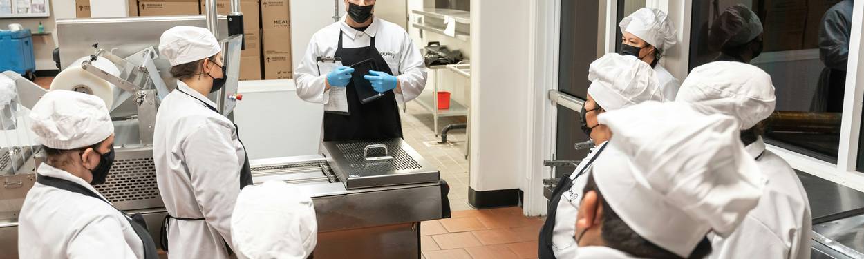 Culinary staff reviewing safe food handling steps during practice test session